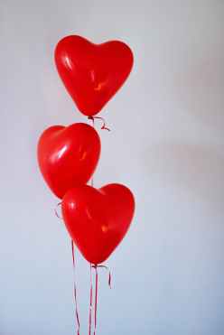 three red heart balloons